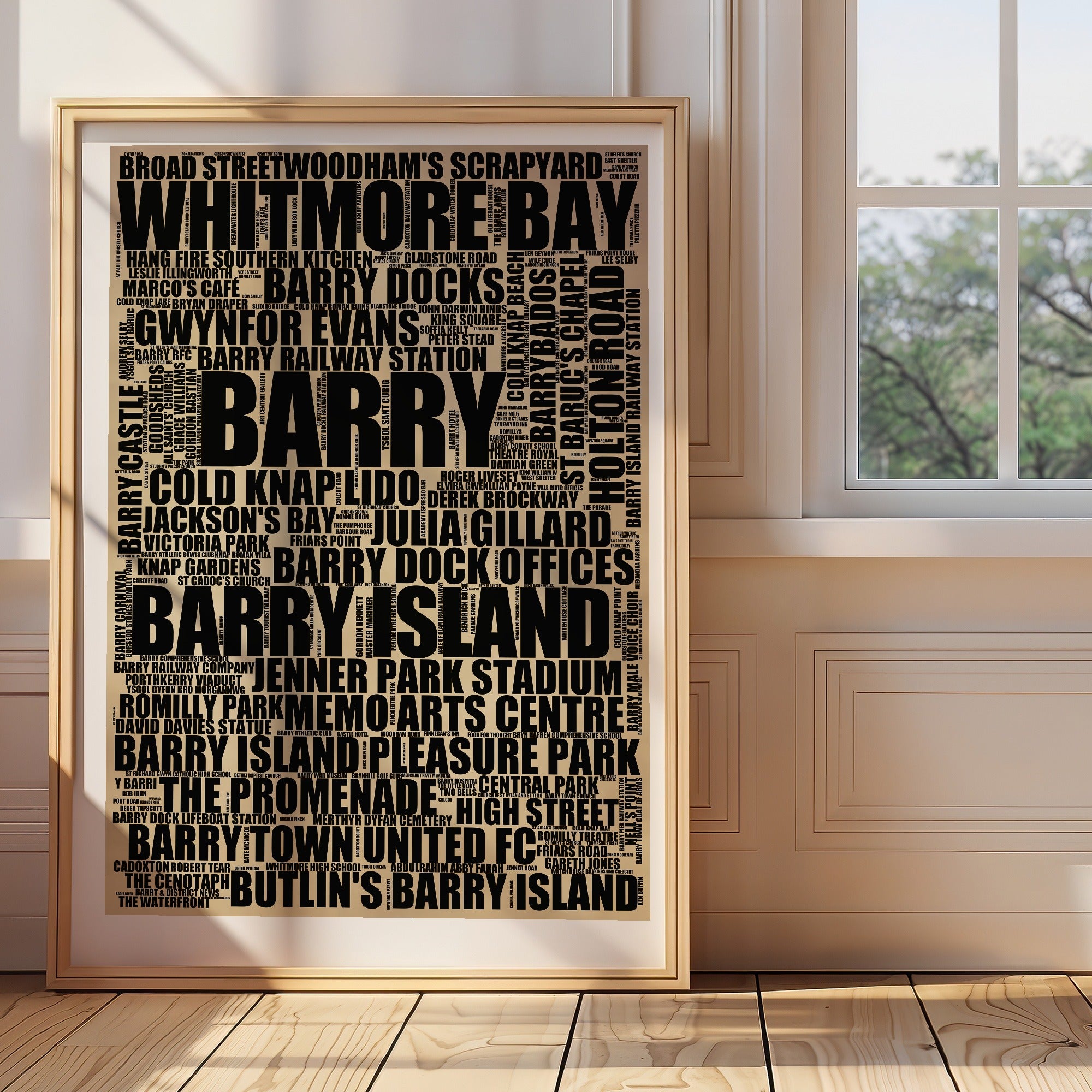 Barry word art print in a brass frame by a window, rustic portrait poster of 250 real Barry places including Whitmore Bay and Barry Docks