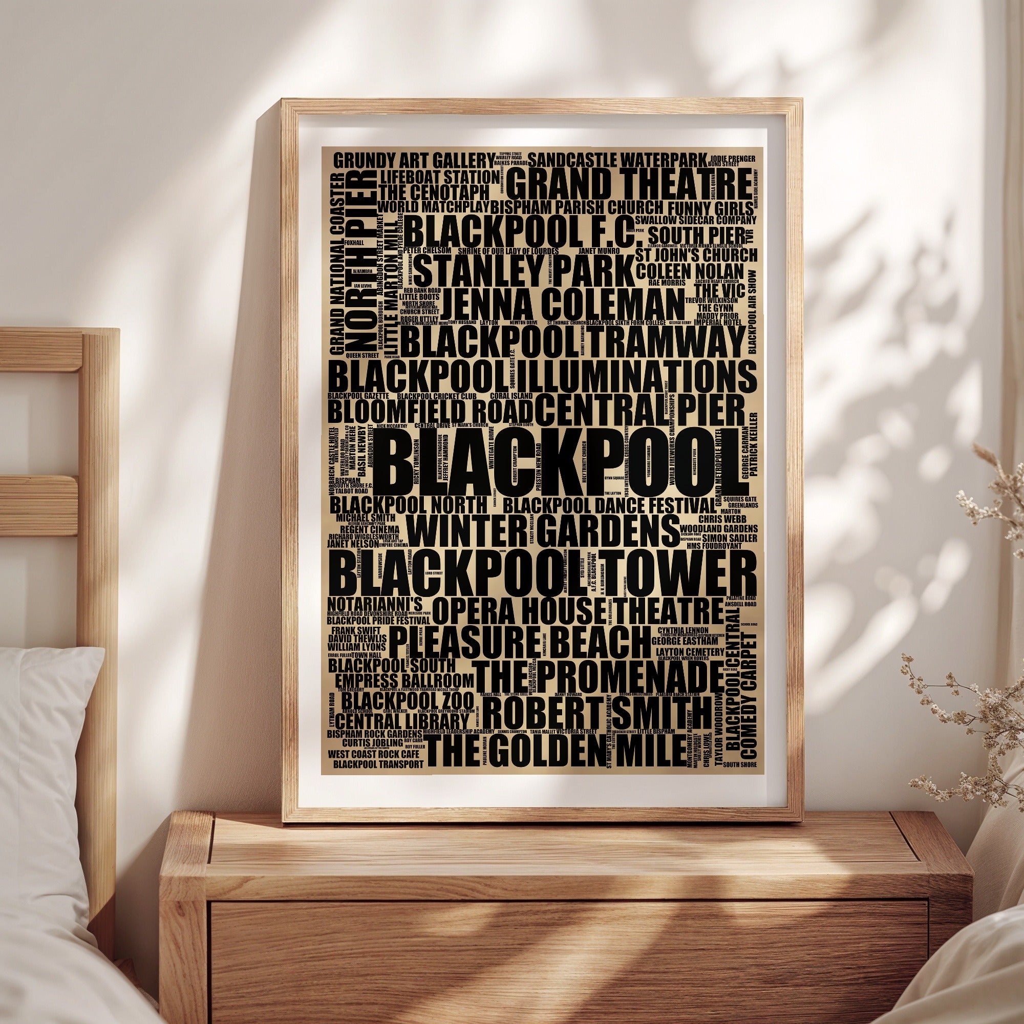 Blackpool word art print in a brass frame by a window, rustic portrait poster of 211 real Blackpool places including Blackpool Tower and Pleasure Beach