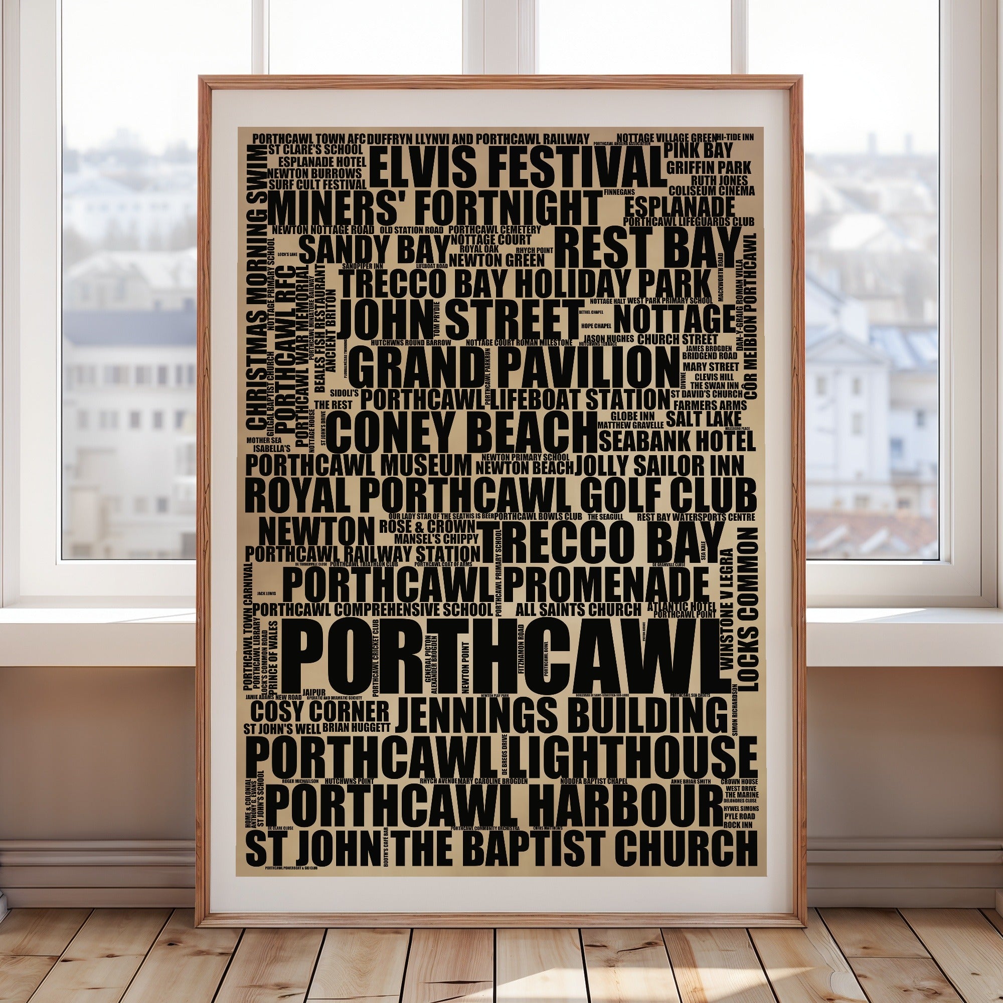 Porthcawl word art print in a brass frame by a window, rustic portrait poster of 155 real Porthcawl places including Porthcawl Lighthouse and Grand Pavilion