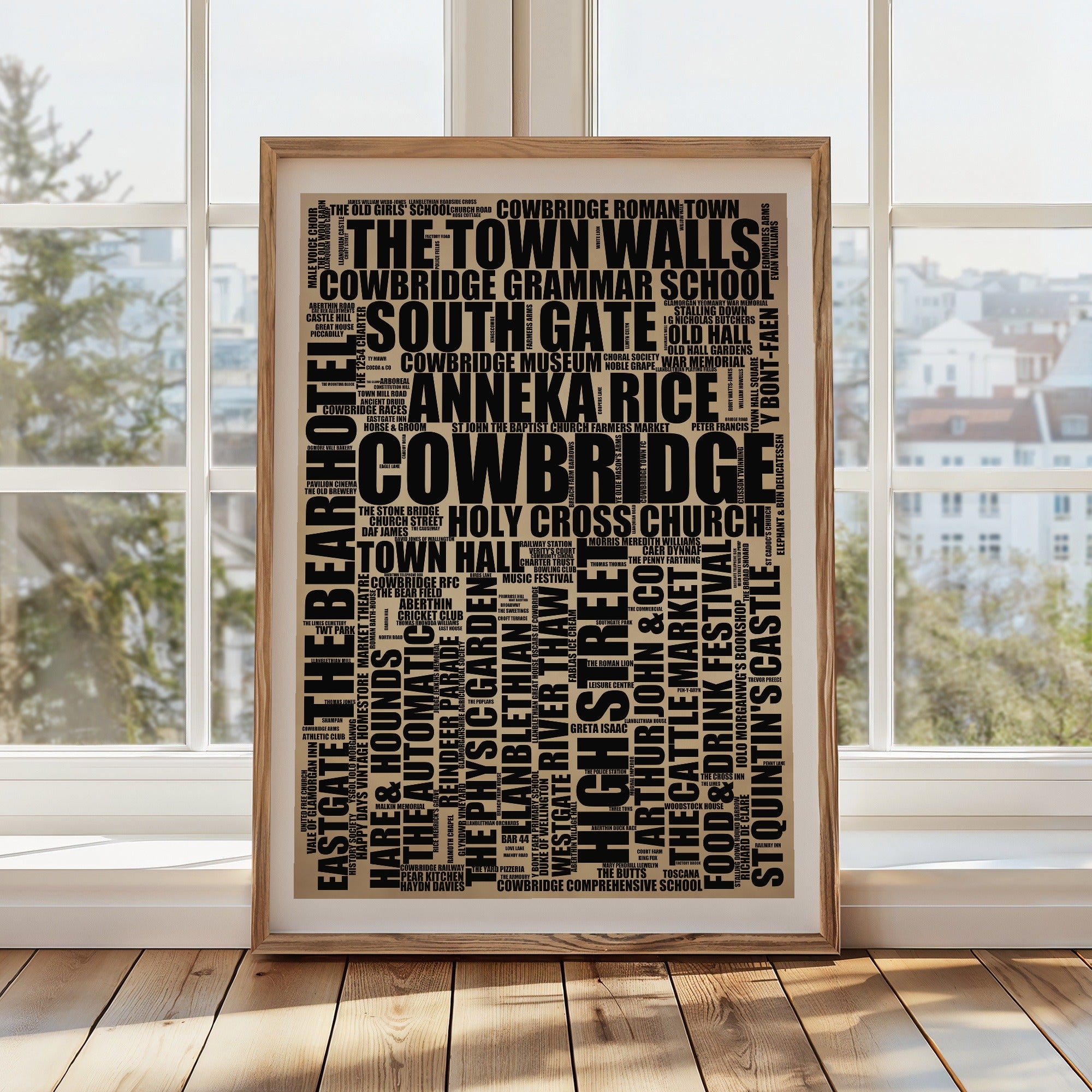 Cowbridge word art print in a brass frame by a window, rustic portrait poster of 186 real Cowbridge places including The Town Walls and South Gate