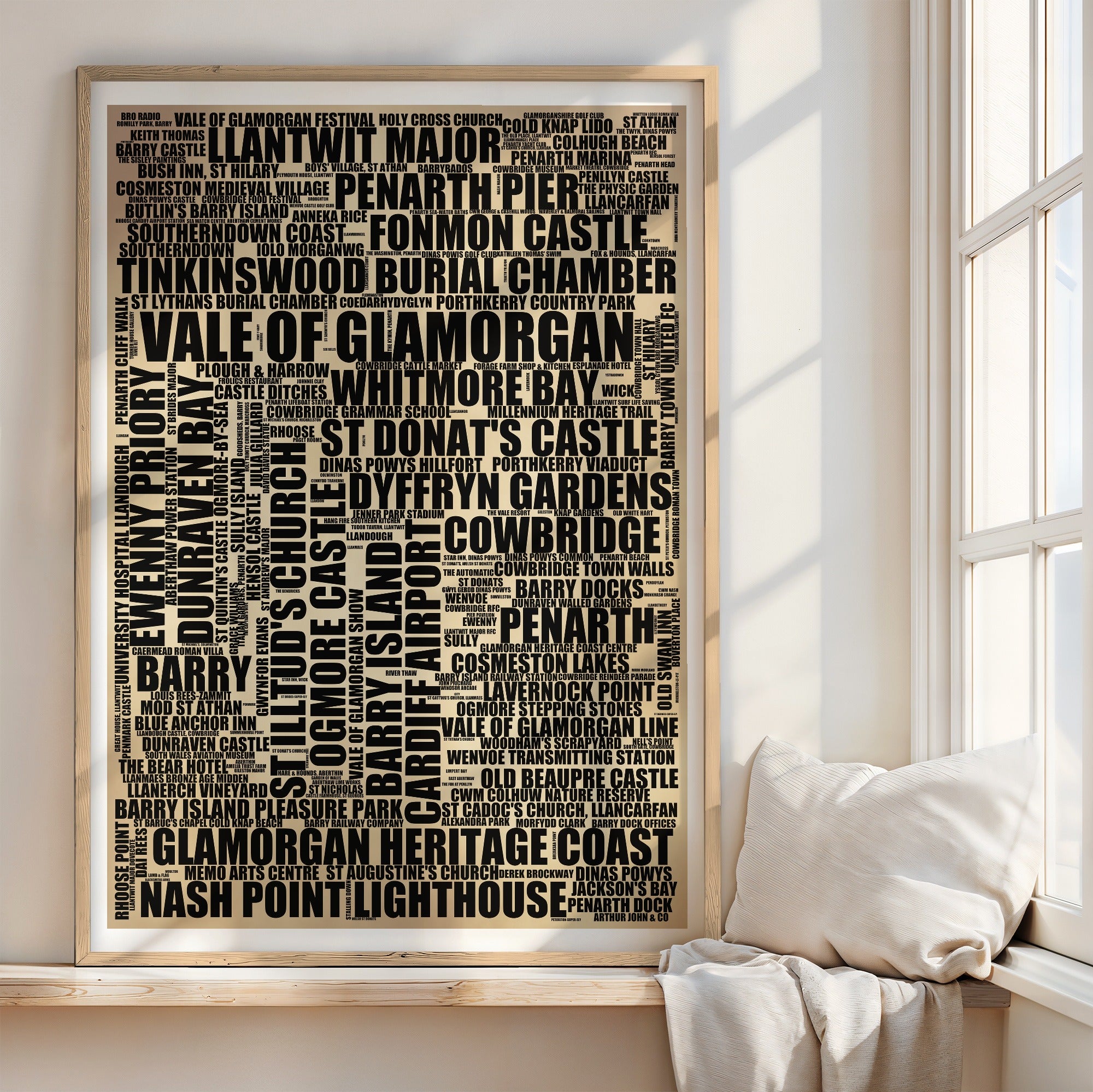 Vale Of Glamorgan word art print in a brass frame by a window, rustic portrait poster of 250 real Vale Of Glamorgan places including Penarth Pier and St Donat's Castle