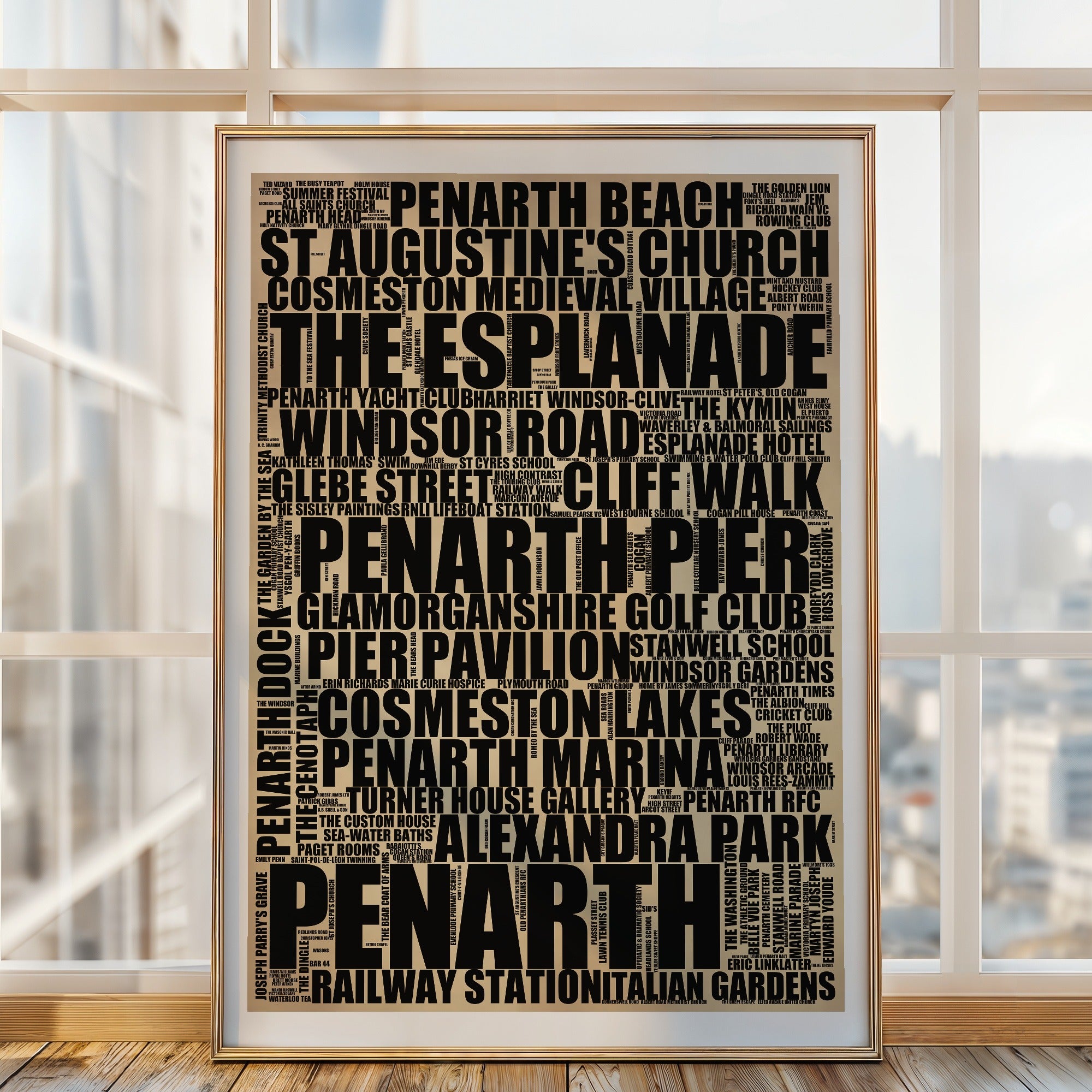 Penarth word art print in a brass frame by a window, rustic portrait poster of 243 real Penarth places including Penarth Pier and The Esplanade