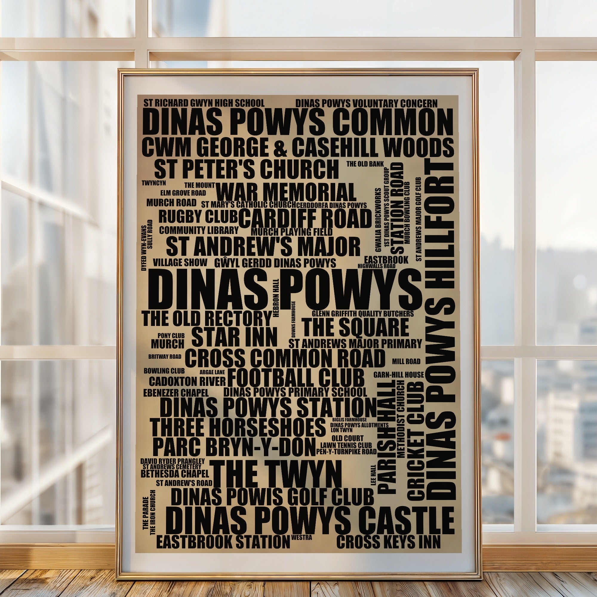 Dinas Powys word art print in a brass frame by a window, rustic portrait poster of 74 real Dinas Powys places including Dinas Powys Hillfort and Dinas Powys Common