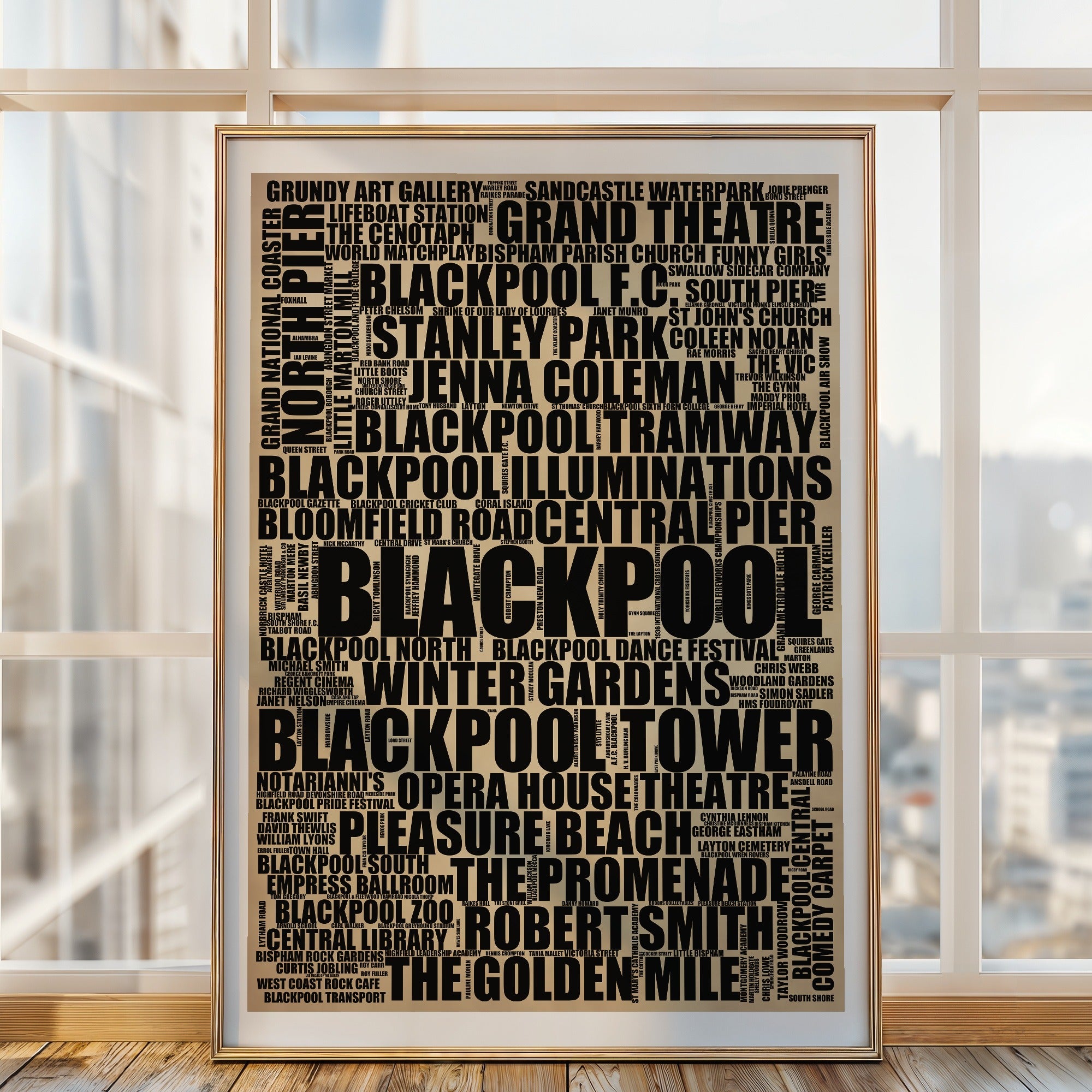 Blackpool word art print in a brass frame by a window, rustic portrait poster of 211 real Blackpool places including Blackpool Tower and Pleasure Beach