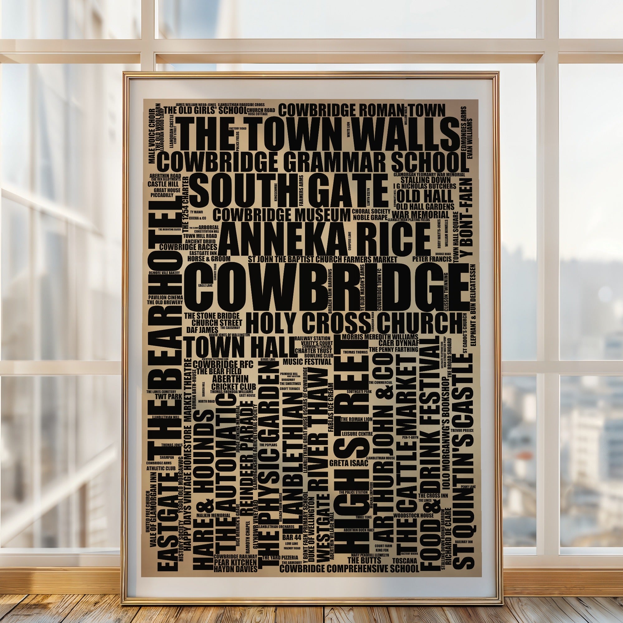 Cowbridge word art print in a brass frame by a window, rustic portrait poster of 186 real Cowbridge places including The Town Walls and South Gate