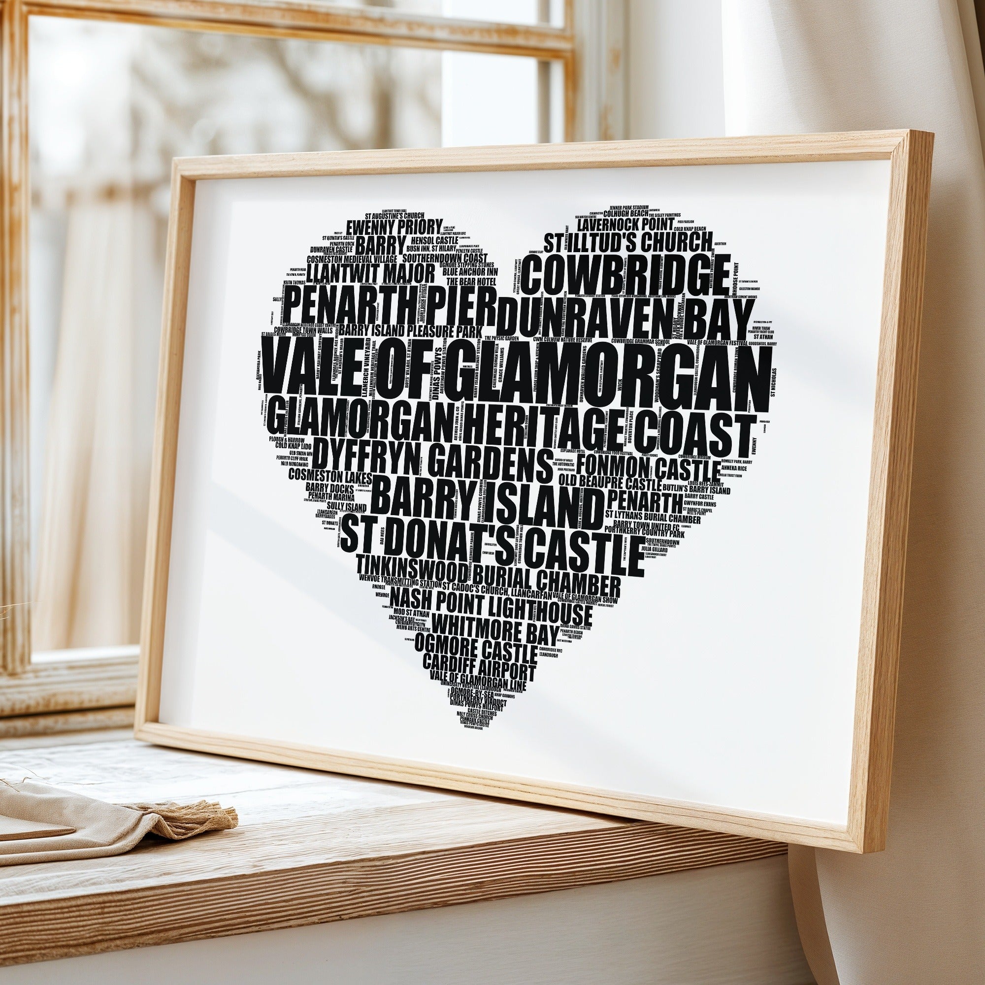 Vale Of Glamorgan heart word art print, white, heart-shaped Vale Of Glamorgan typography poster on a windowsill